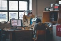 Professional reviewing data analytics on a laptop in a modern office