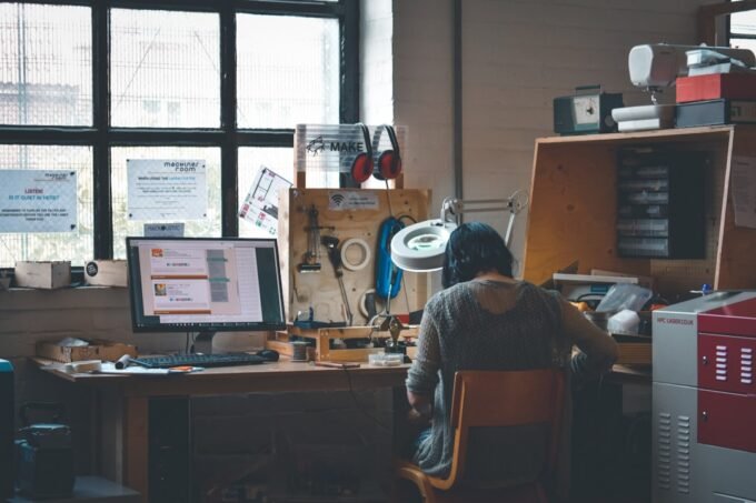 Professional reviewing data analytics on a laptop in a modern office