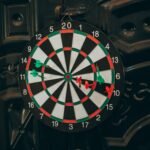 Professional darts player throwing a dart at a target board