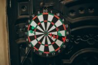 Professional darts player throwing a dart at a target board