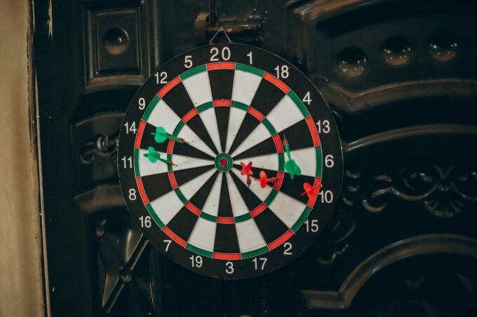 Professional darts player throwing a dart at a target board
