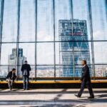 Business professionals in a modern London office with the City skyline in view