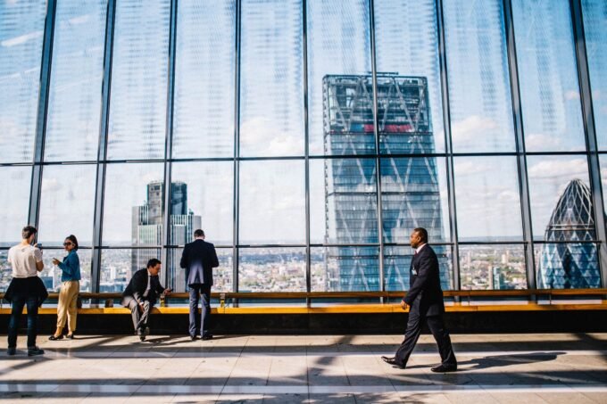 Business professionals in a modern London office with the City skyline in view